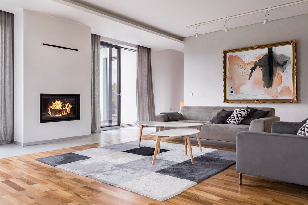 A modern living room renovation with a fireplace and french doors.