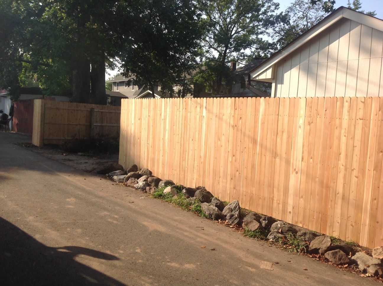 A wooden fence along the side of a road