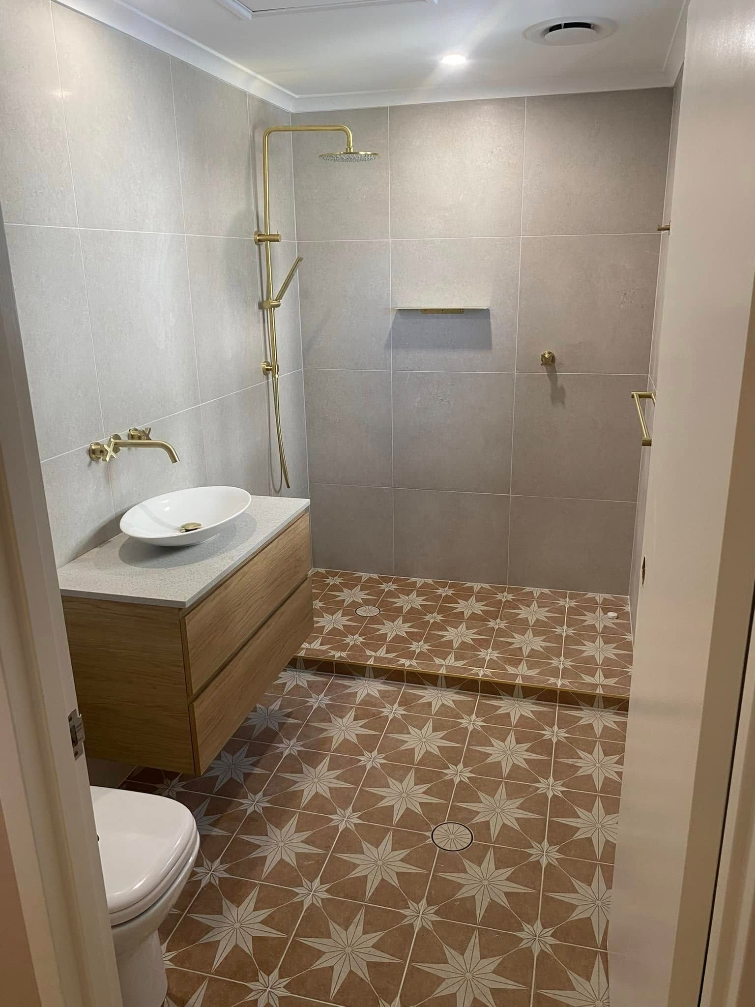 Bathroom with Wood Vanity, Gold Fixtures, Patterned Floor Tiles — 2 Foote Plumbing & Gas in Darwin, NT