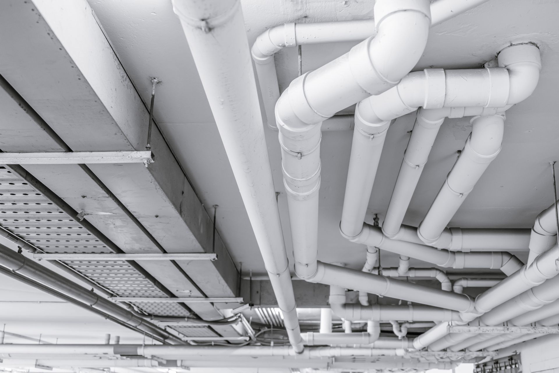 White Pipes and Conduit on A Ceiling, Possibly in A Utility Room — 2 Foote Plumbing & Gas in Darwin, NT