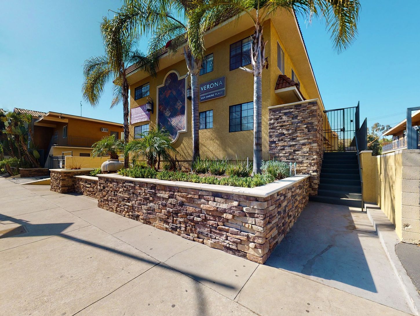 A yellow building with stairs leading up to it
