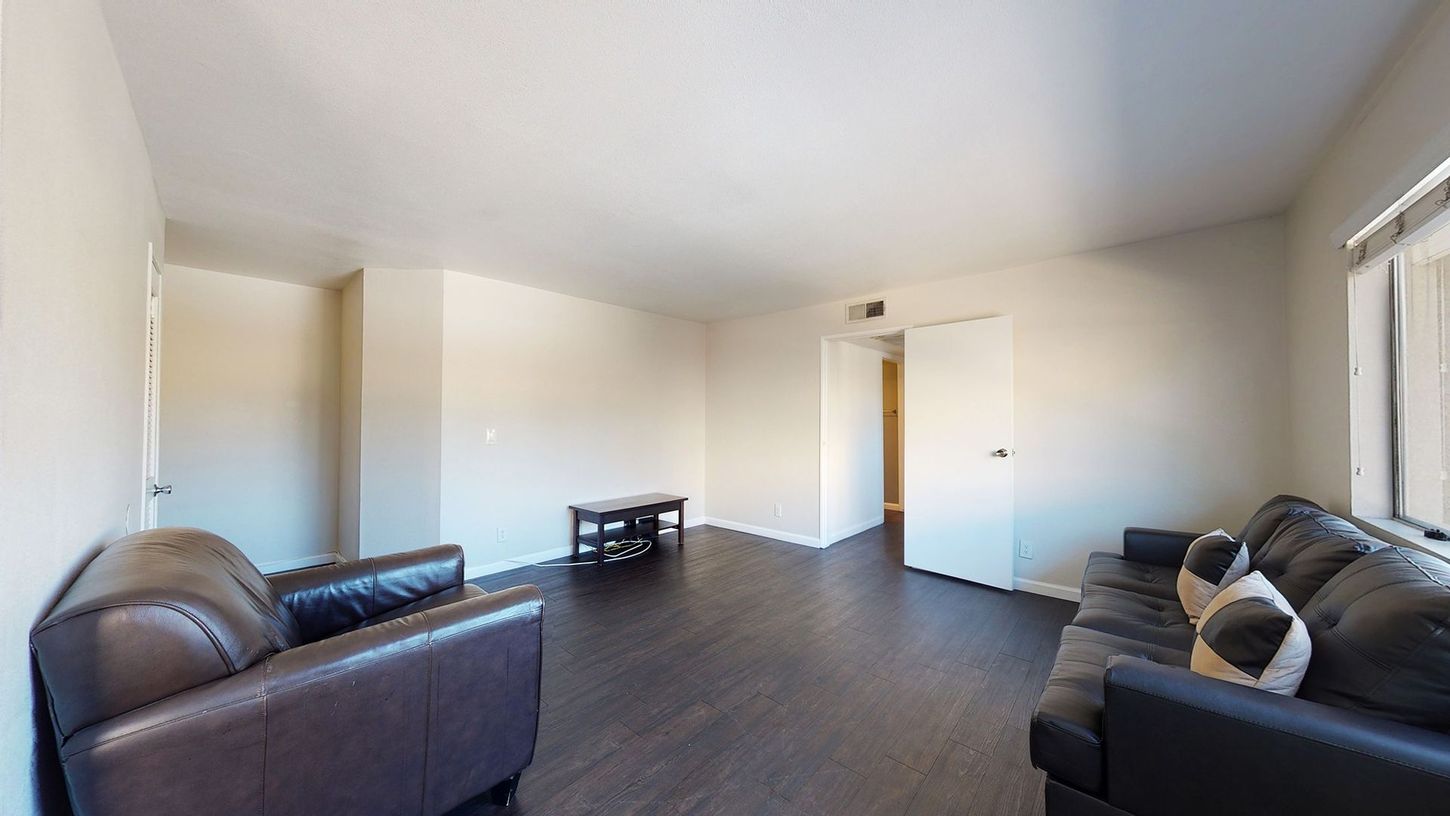 A living room with a couch , chair , and table.