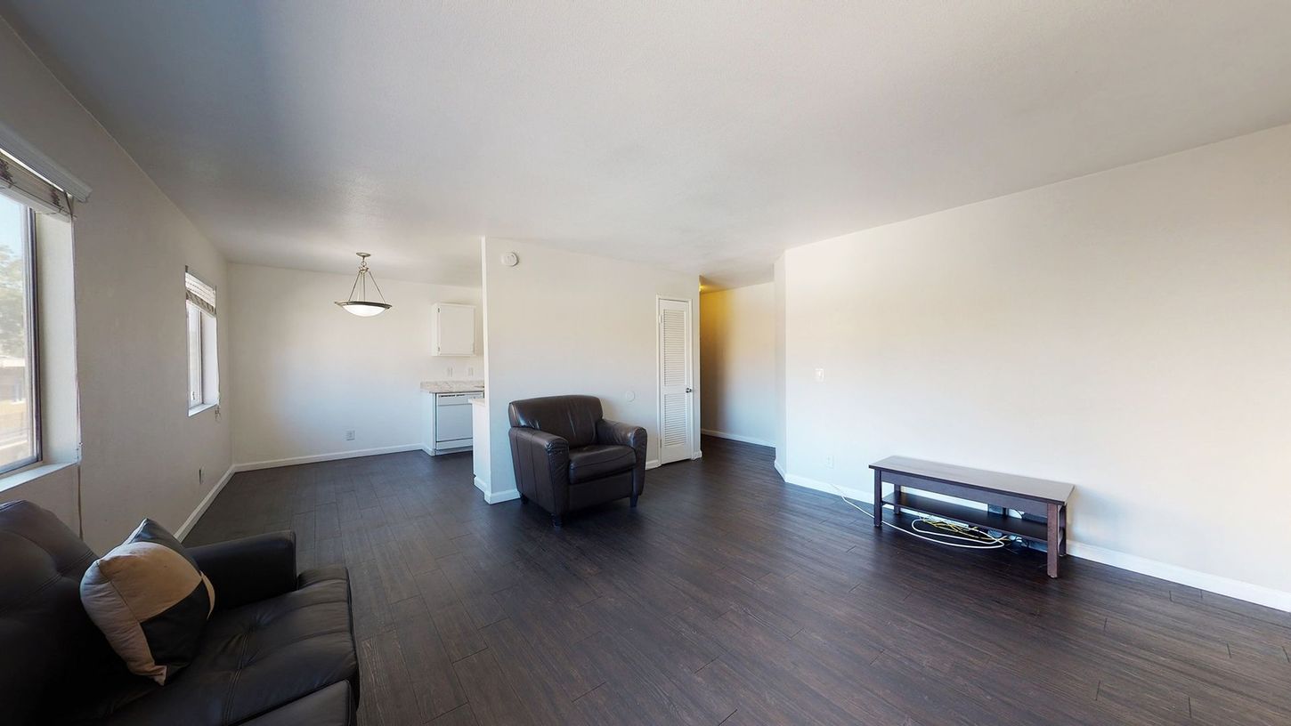 A living room with a couch , chair , and table.