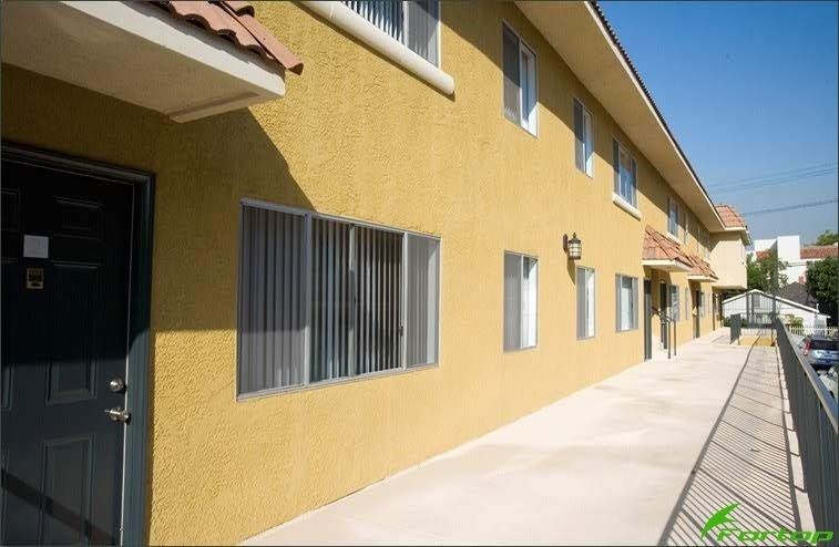 A yellow apartment building with a black door