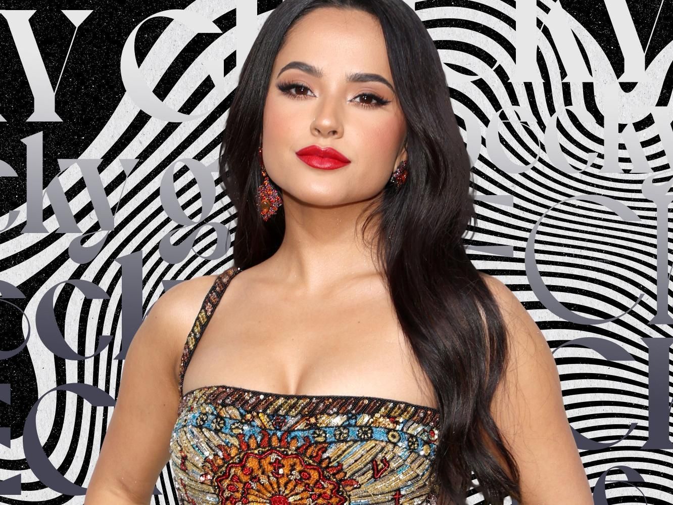 a woman in a dress with red lipstick is standing in front of a black and white striped background .