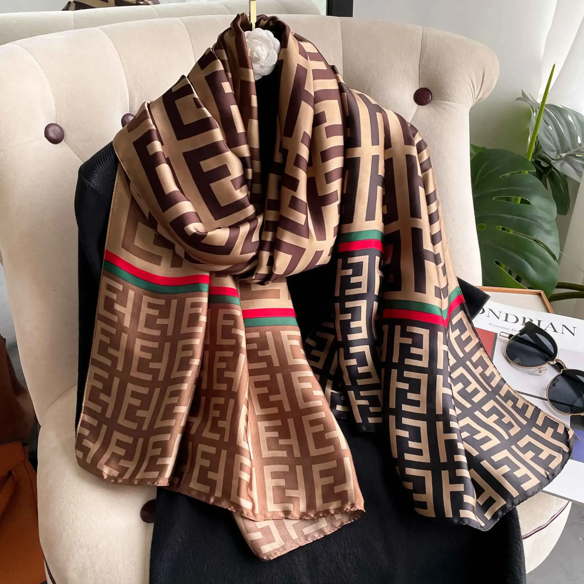 a scarf with a fendi pattern is sitting on a chair .