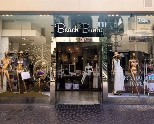 a beach bunny store with mannequins in front of it