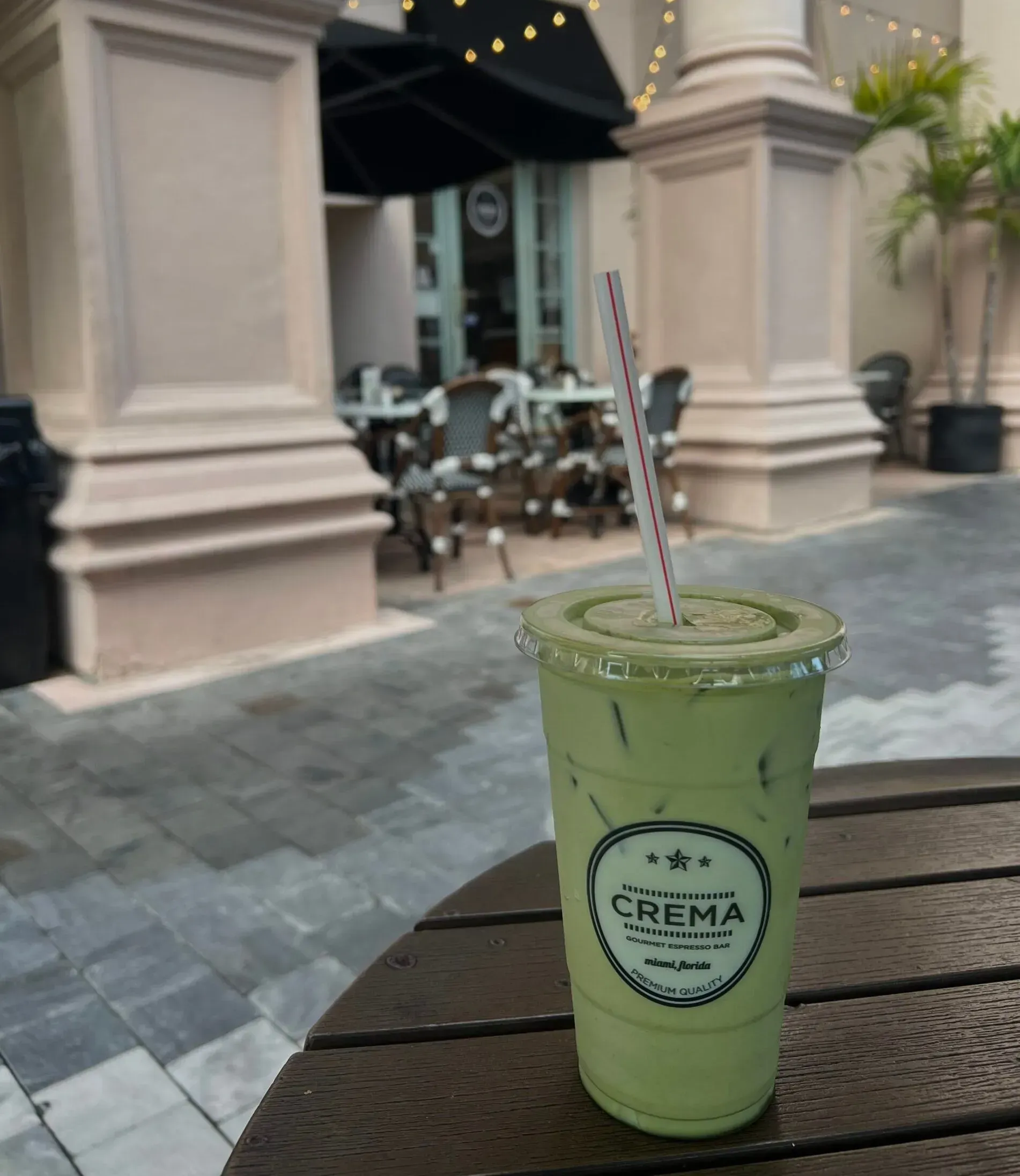 a green drink in a plastic cup with the word chima on it