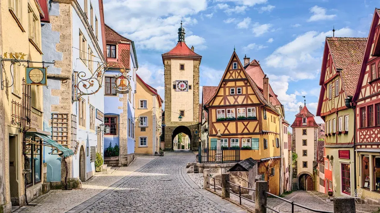 a narrow cobblestone street lined with buildings in a small town .