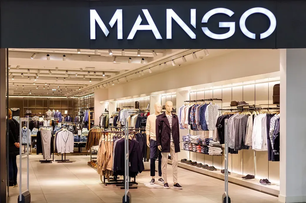 a mango store with a lot of clothes on display .