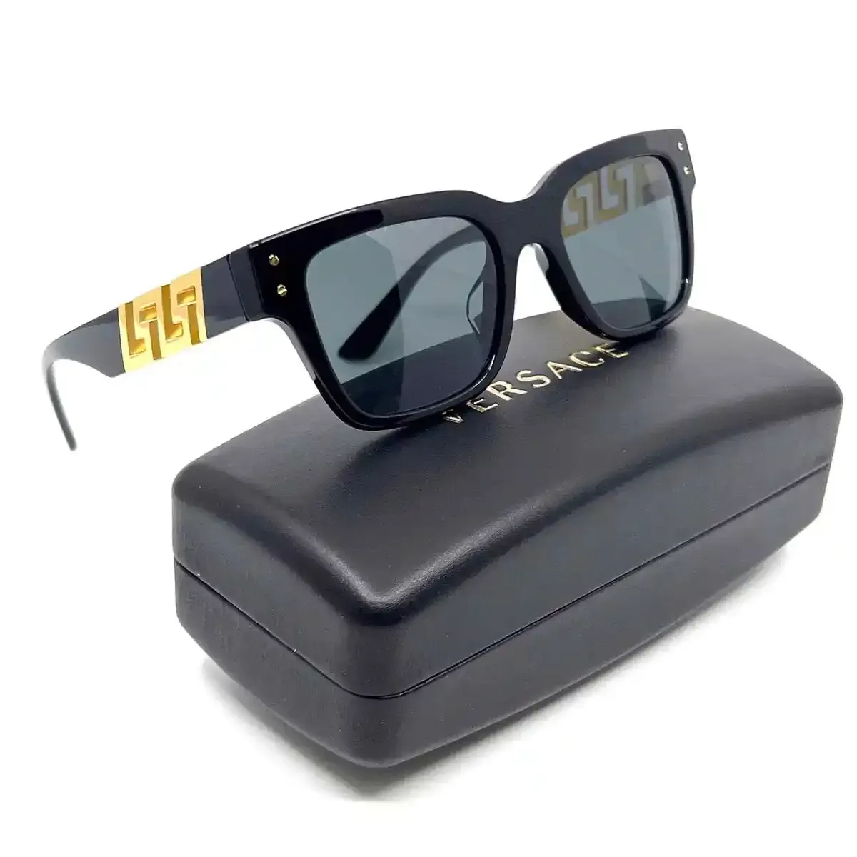 a pair of versace sunglasses sitting on top of a black case