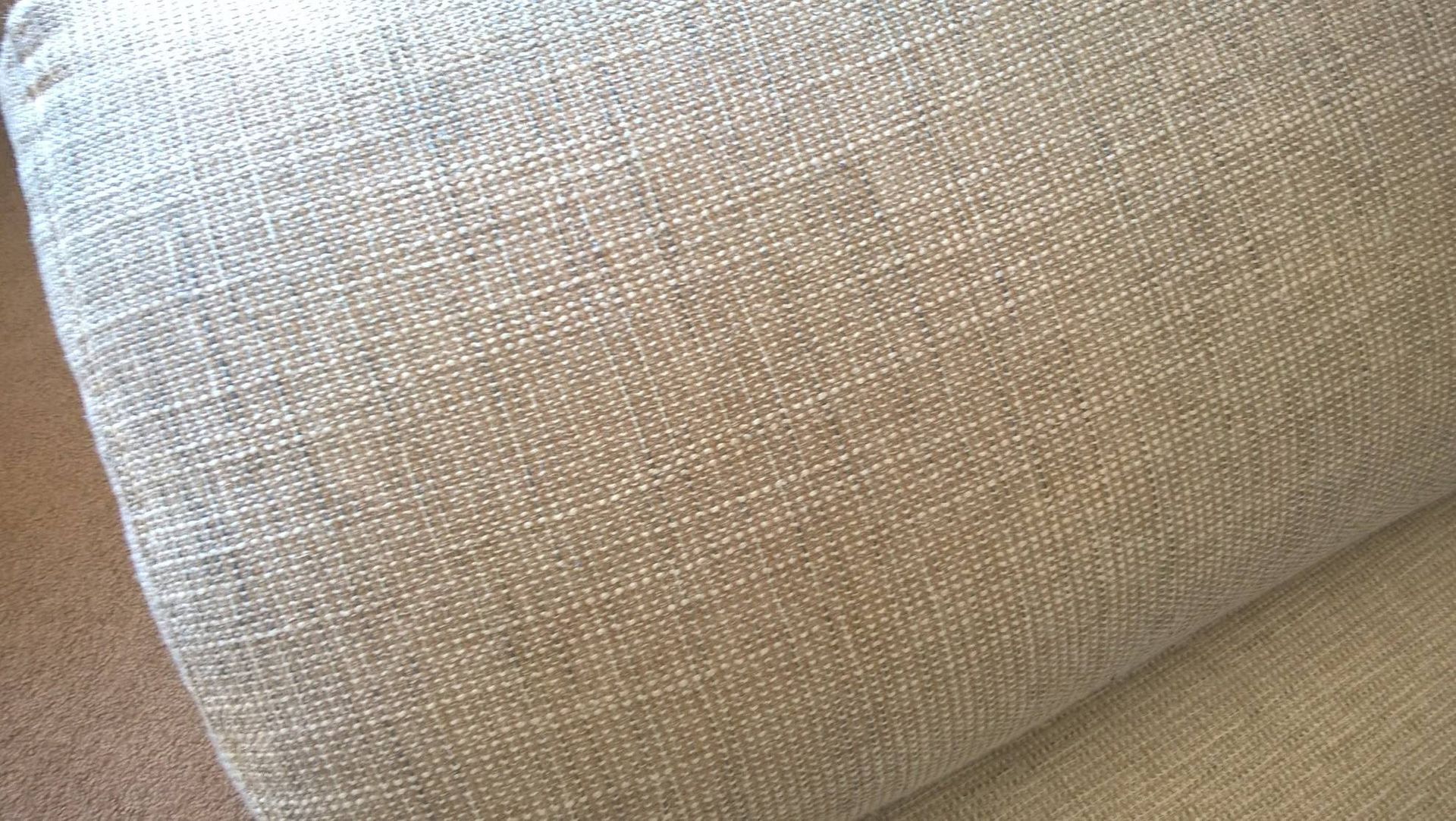 A close up of a pillow on a couch.