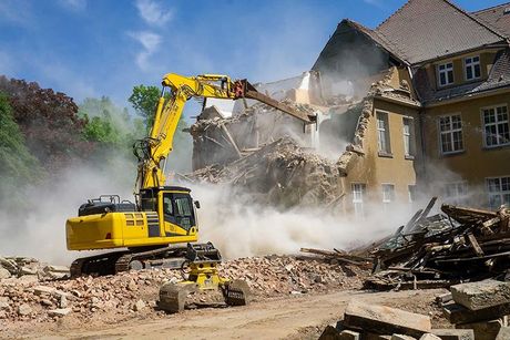 Construction industrial site digger yellow demolishing house for reconstruction 
