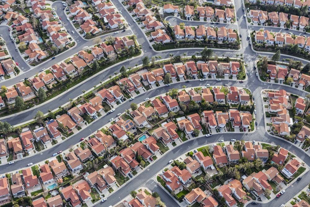 An aerial view of a residential neighborhood with lots of houses and trees.