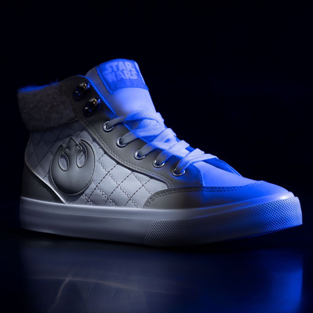 A pair of star wars high top sneakers are glowing in the dark