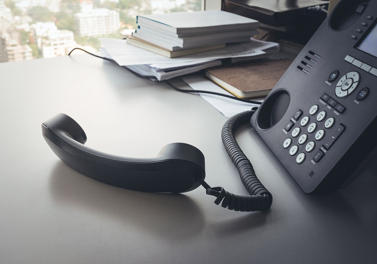 Black office phone on a desk