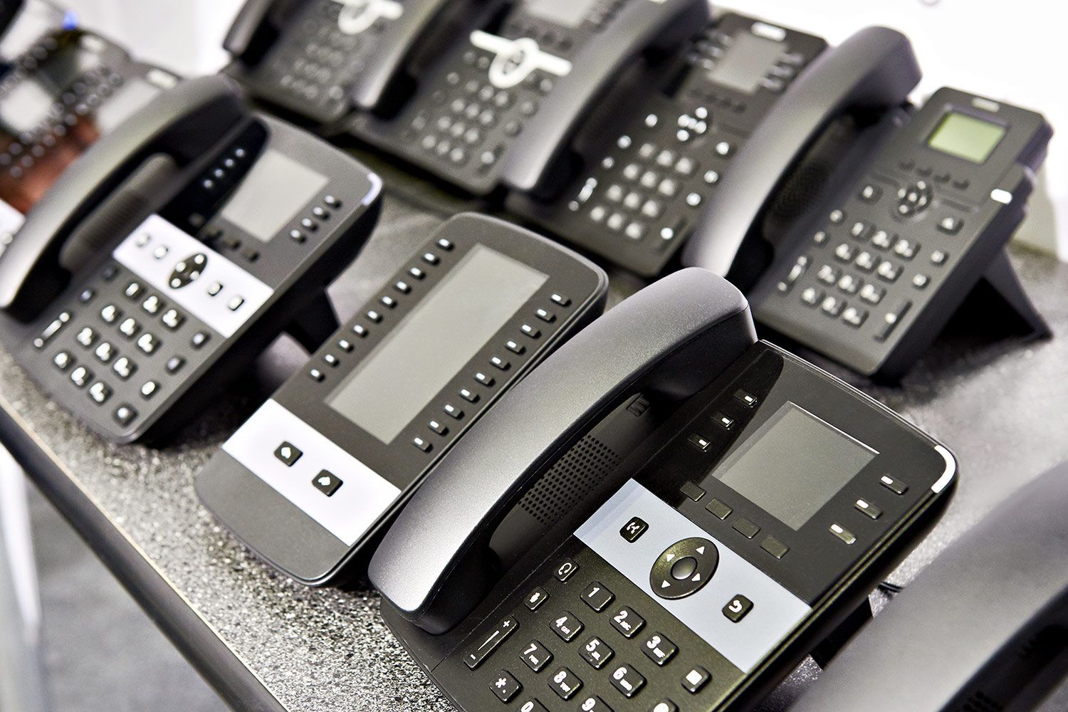Row of business phones on table Row of business phones on table