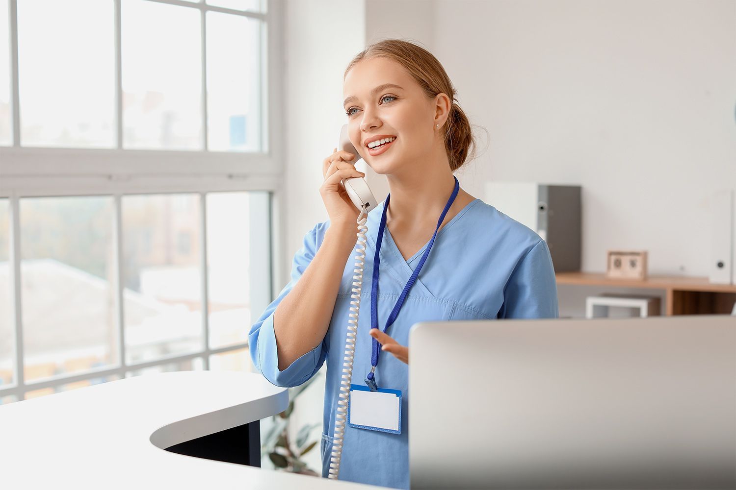 Medical receptionist answering a call Medical receptionist answering a call