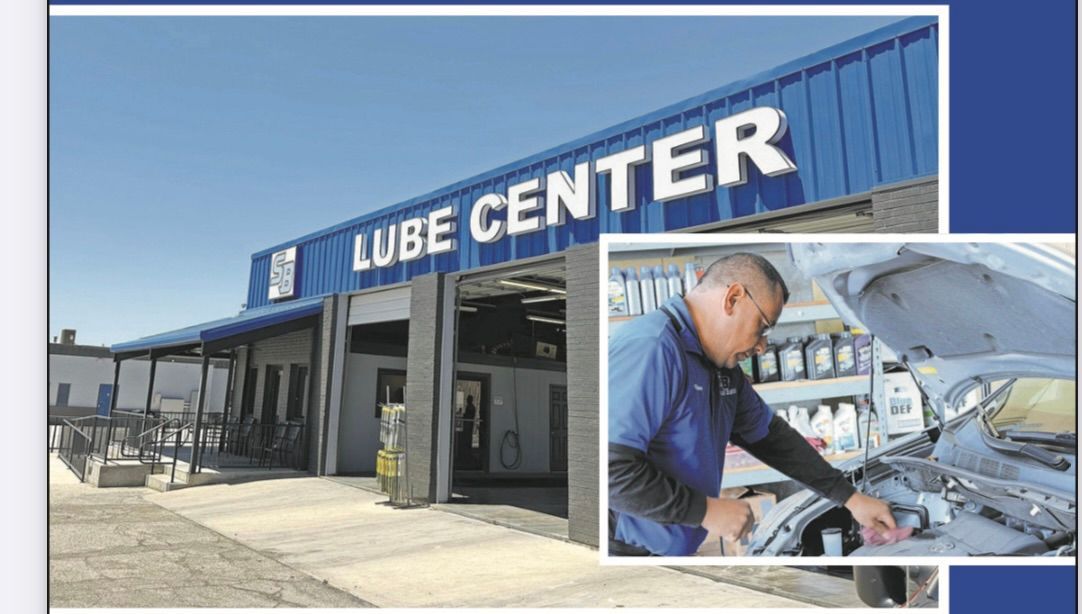 Lube Center building with blue signage and an inset of a mechanic working on a car.