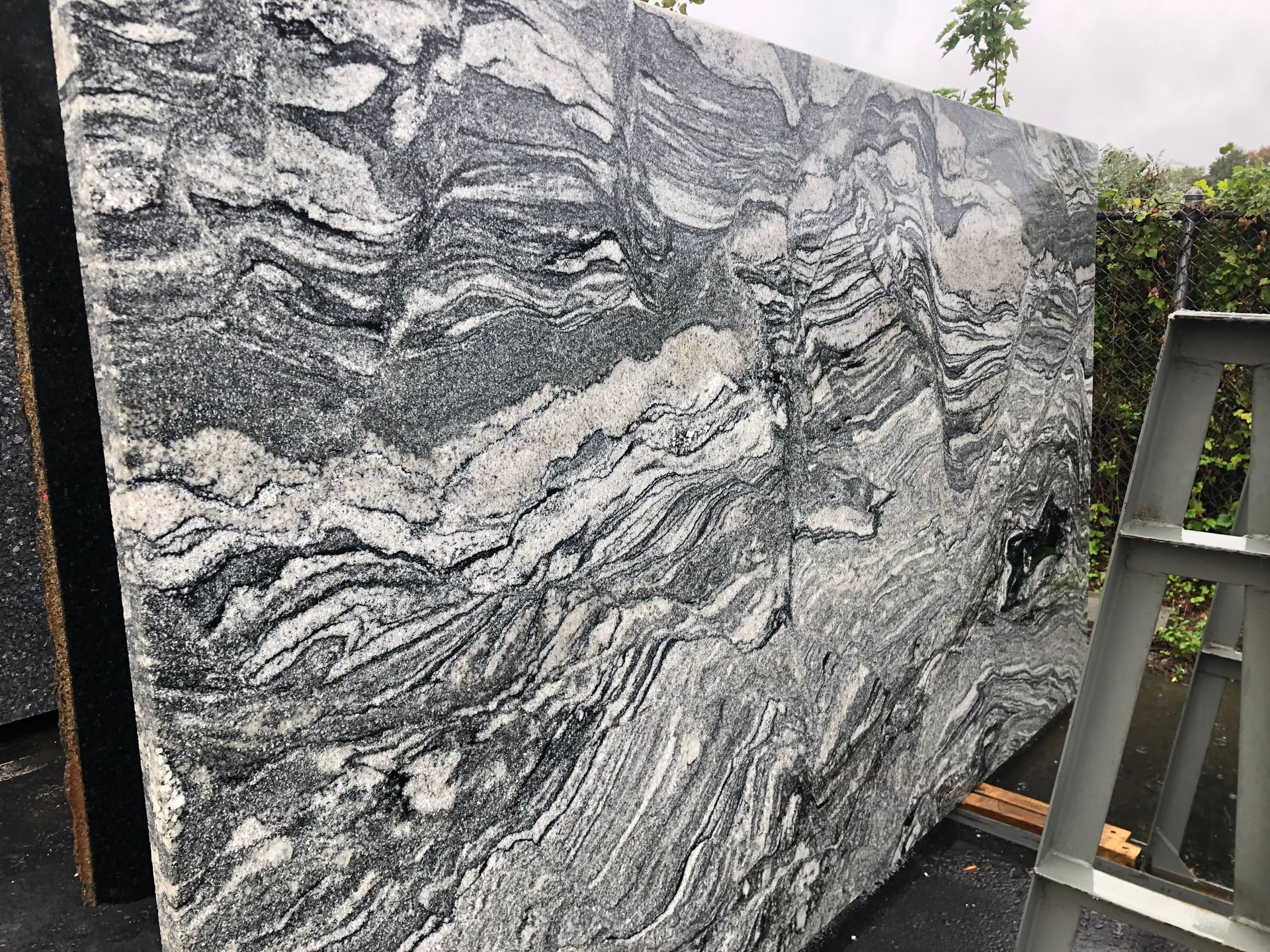 Large slab of granite with swirling patterns in shades of gray and white.