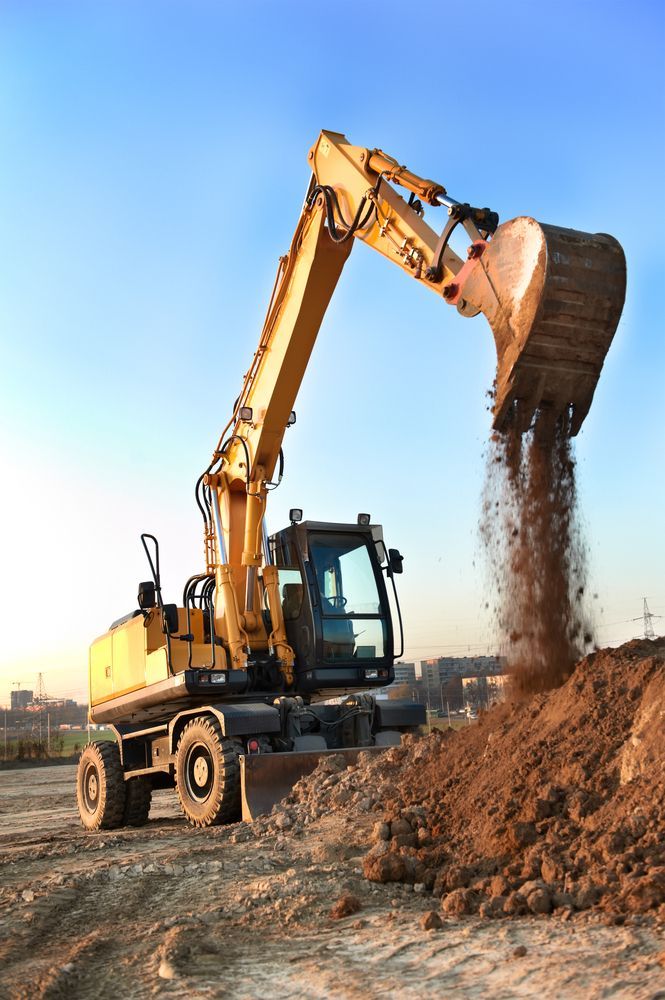 A Yellow Excavator is Digging a Pile of Dirt on a Construction Site — Dino's Bobcat–Bitumen & Excavator Hire in Kingaroy, QLD