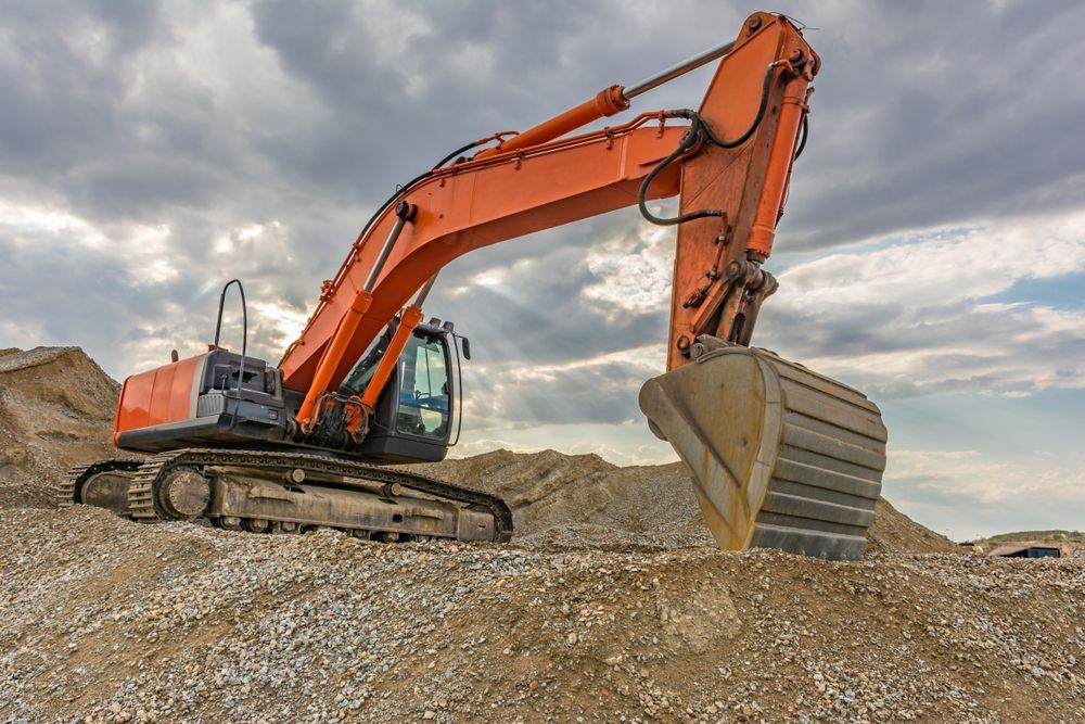 A Large Orange Excavator is Sitting on Top of a Pile of Dirt — Dino's Bobcat–Bitumen & Excavator Hire in Kingaroy, QLD