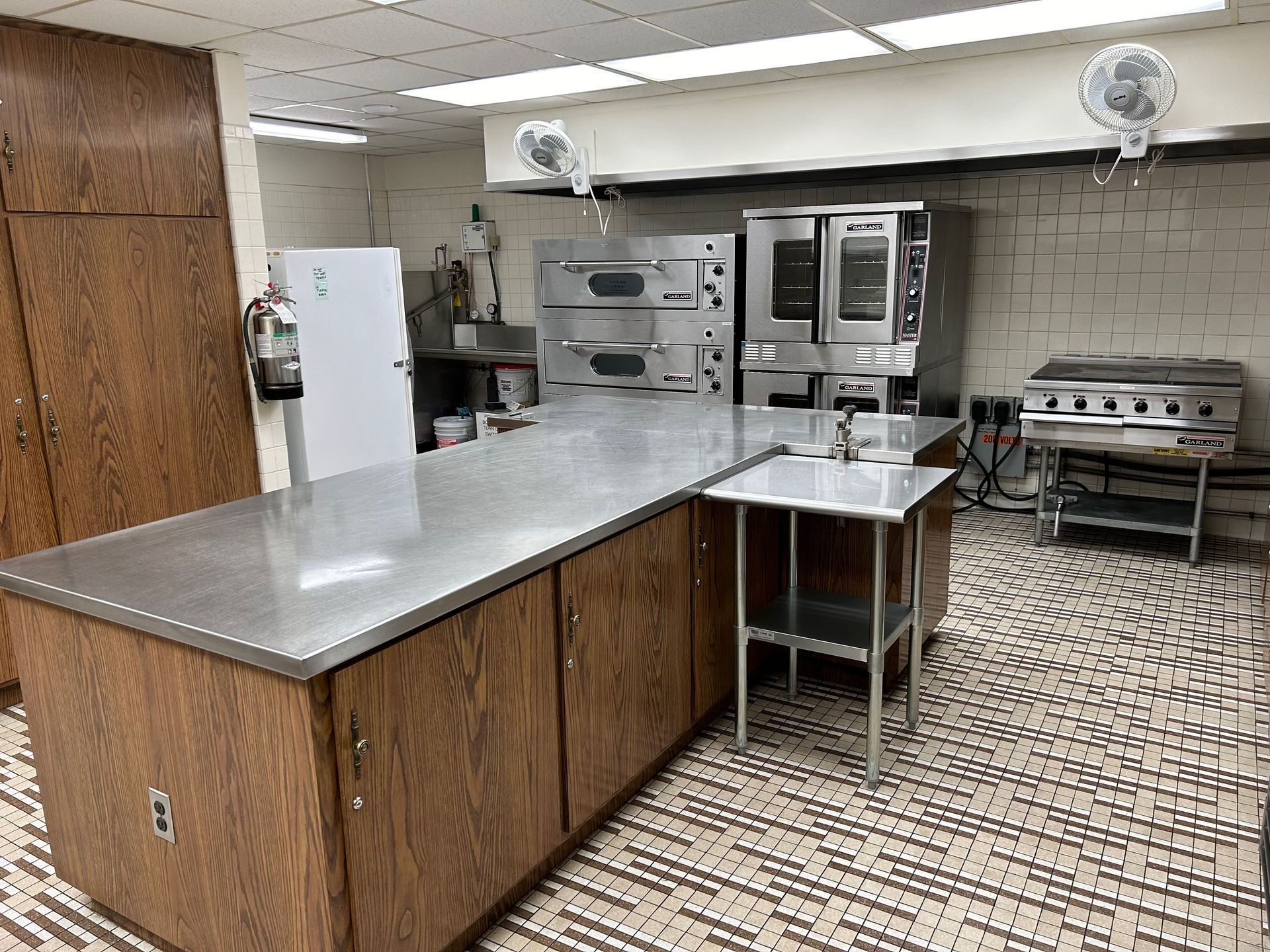 Restaurant manager satisfied with a spotless commercial kitchen