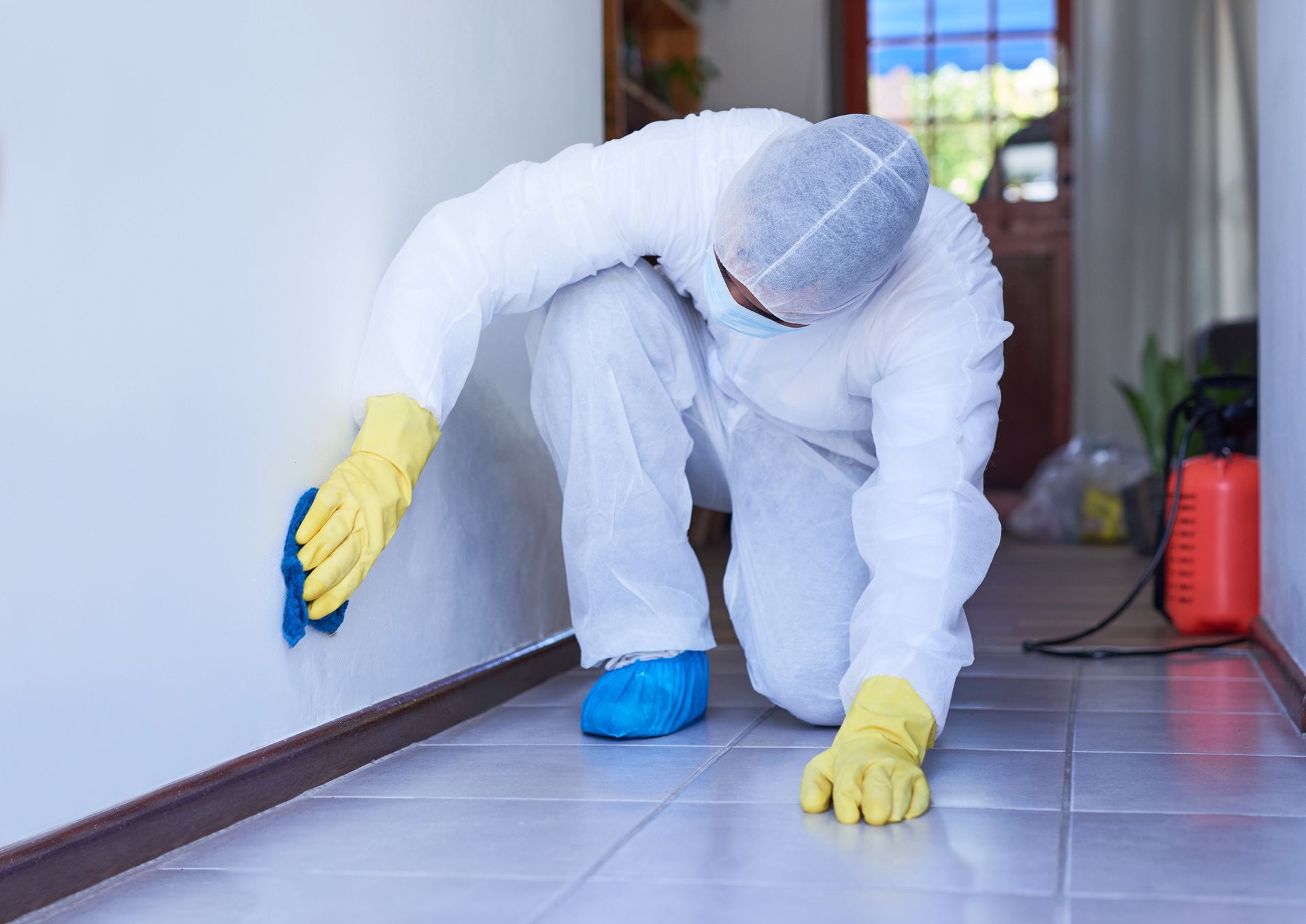 Certified technician performing biohazard remediation and sanitization in a commercial building