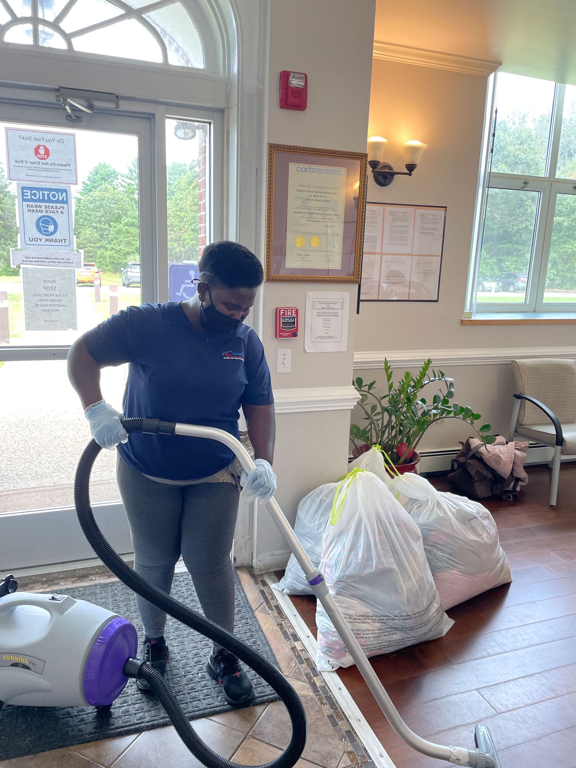 On-site cleaning staff wiping down a reception desk during business hours
