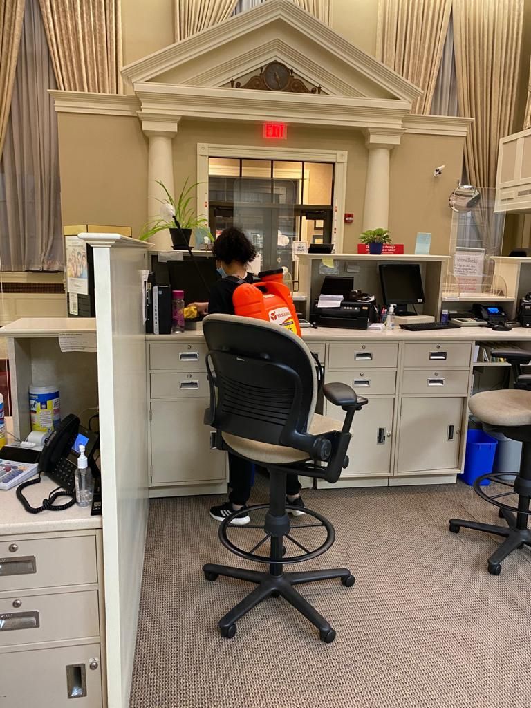 cleaning a desk in an office
