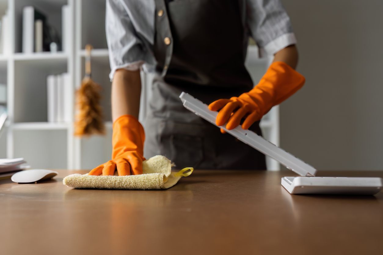 cleaning a desk in an office