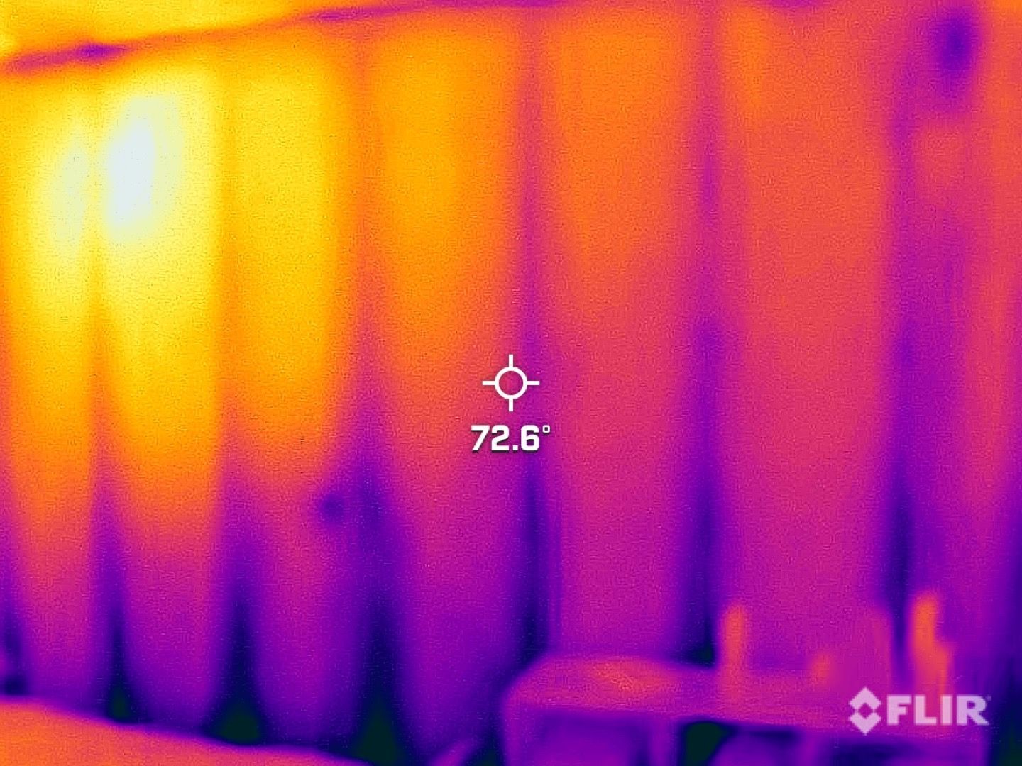 FLIR thermal view of a wall and furniture, with a 72.6°F temperature reading and crosshair center mark
