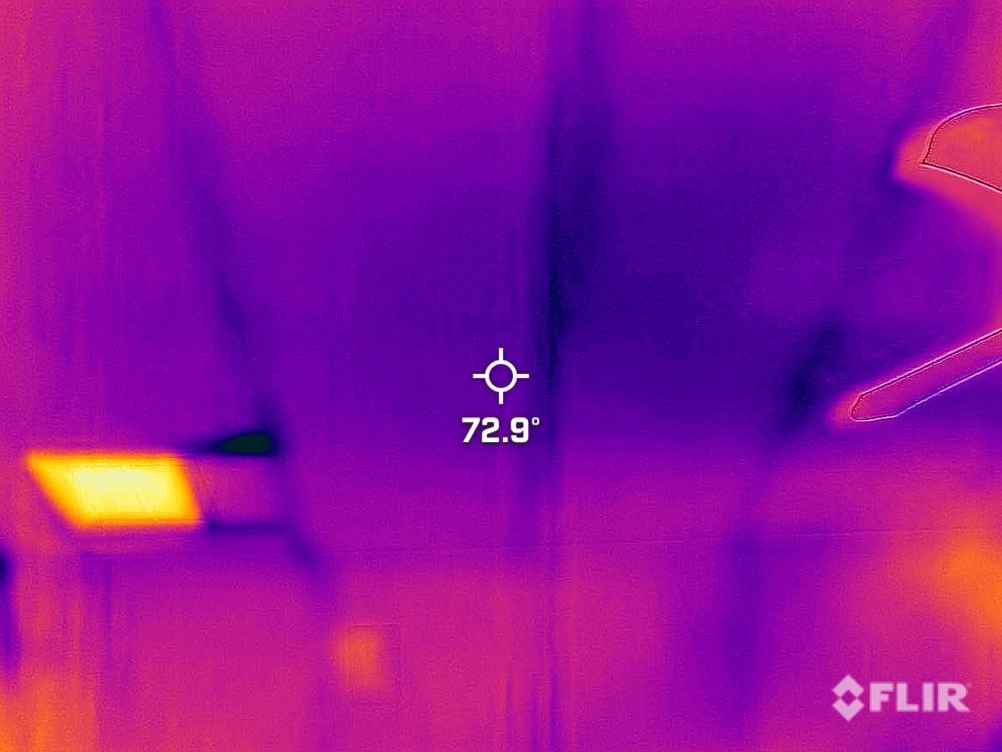FLIR thermal view of a room wall with hot orange spots and a 72.9° measurement marker