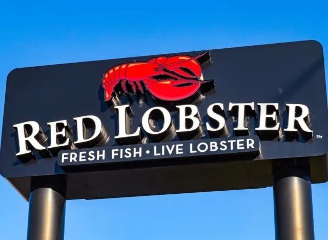 Red Lobster restaurant sign with red lobster logo against a blue sky