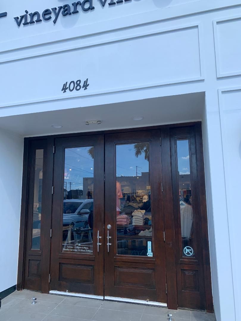 Storefront with dark wooden double doors and the number 4084 above the entrance
