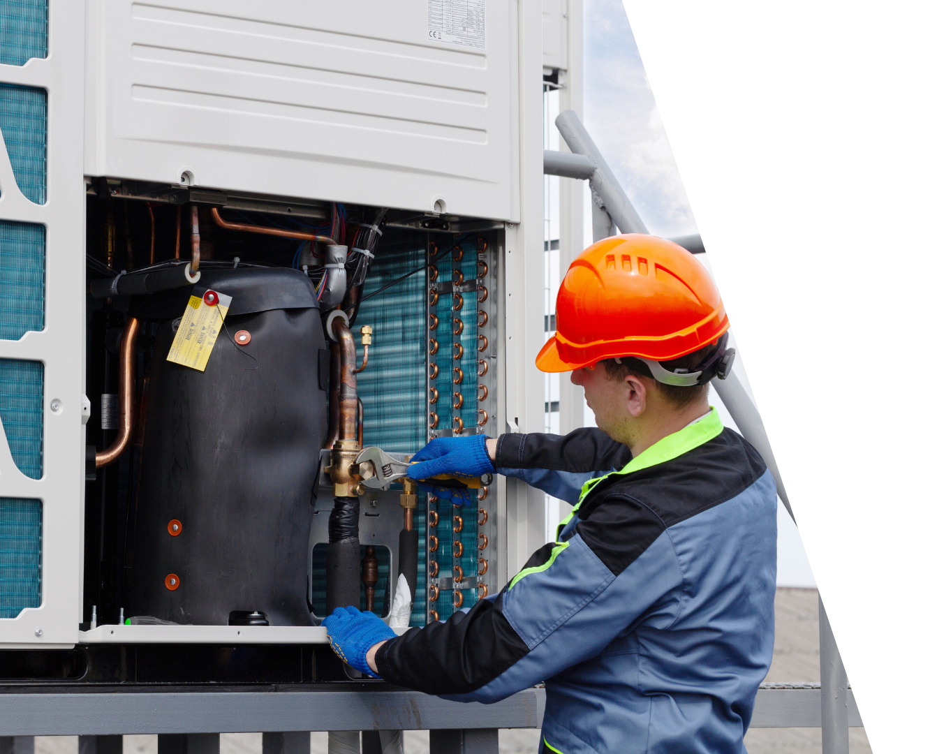 Learn More About Amana Products Technician in orange hard hat inspecting HVAC unit with blue gloves