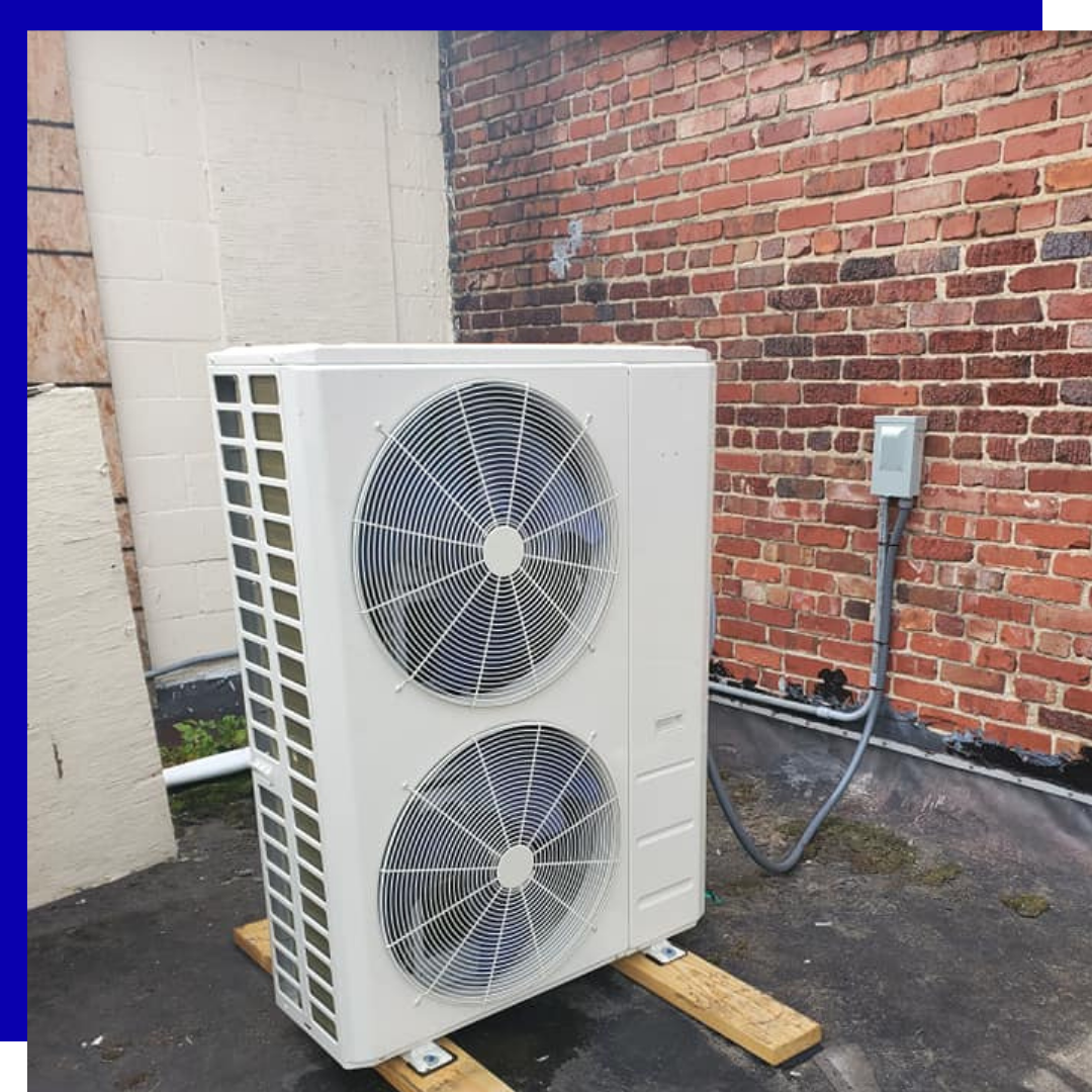 Contact Us Outdoor air-conditioning unit beside a brick wall on a concrete pad, with two large fans visible.