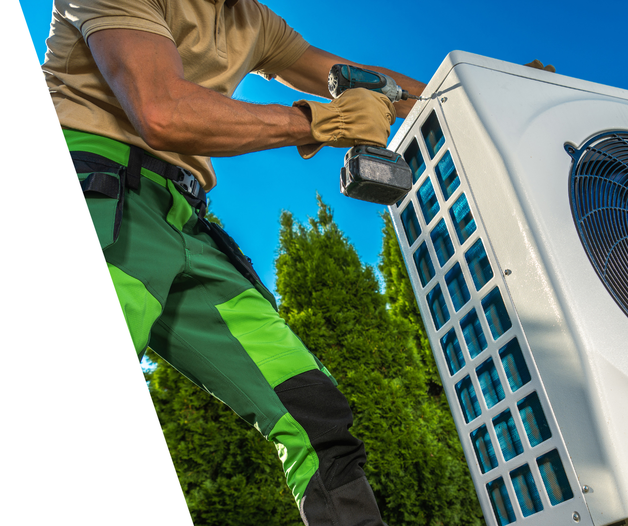 Contact Us! Technician using a drill to service an outdoor air conditioning unit near green trees