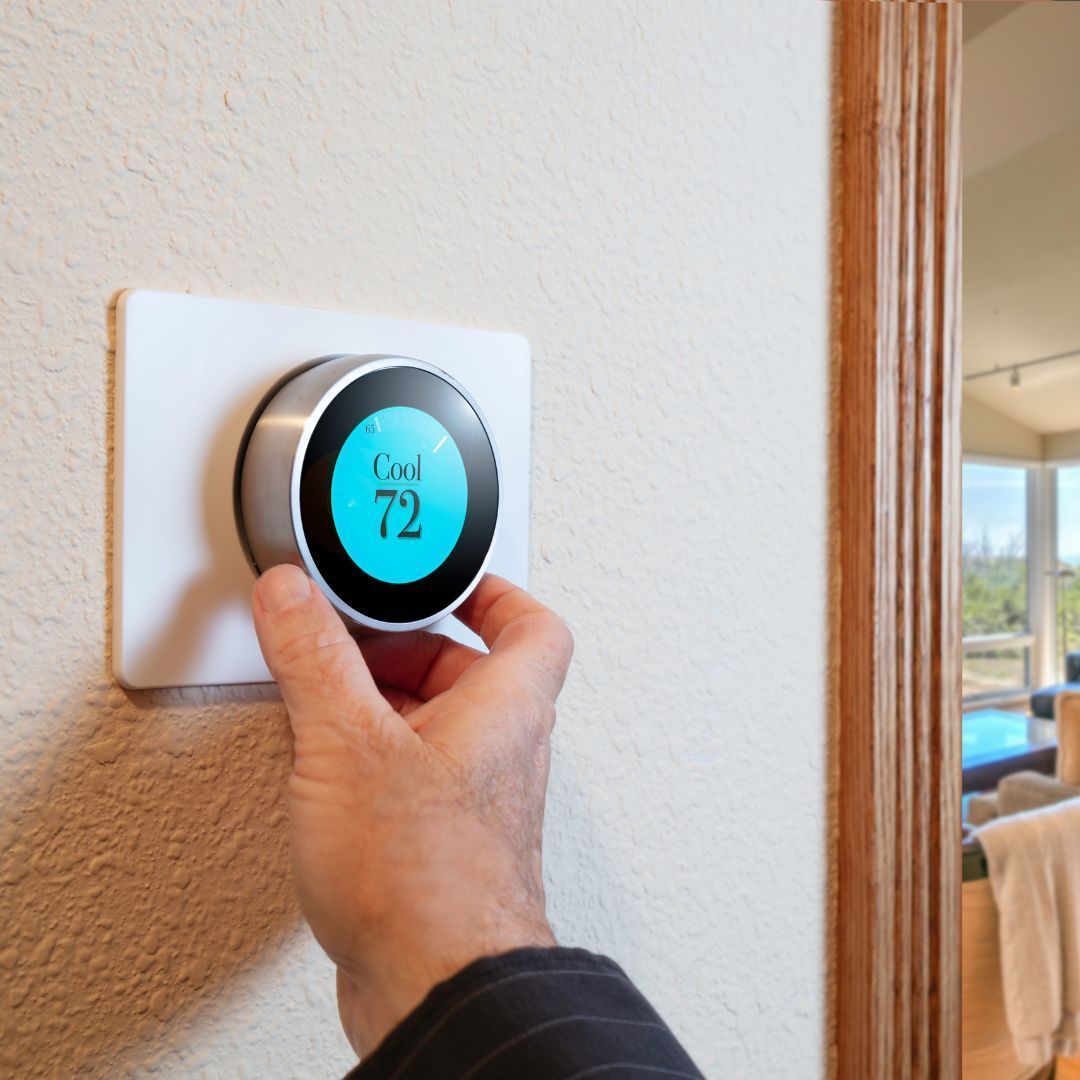 Our HVAC Services A person is adjusting a thermostat to 72 degrees