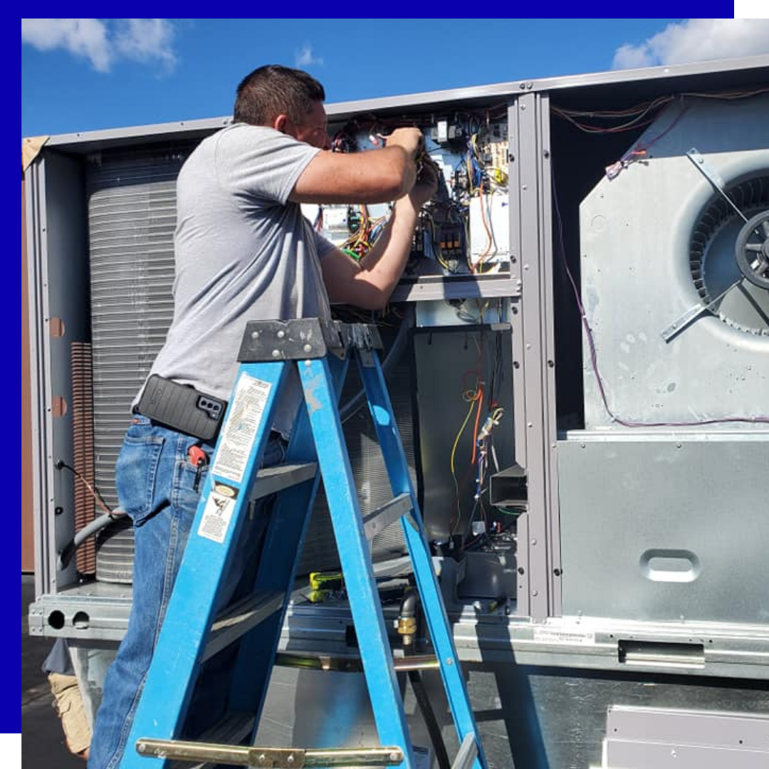 Contact Us Technician on a blue ladder repairing HVAC equipment inside an open rooftop unit
