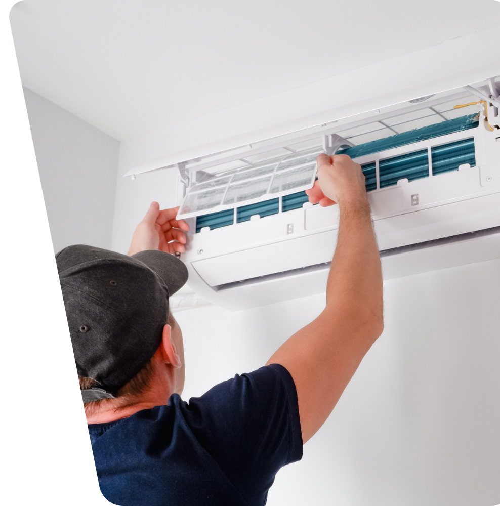 Contact Us Person cleaning or replacing a wall-mounted air conditioner filter indoors