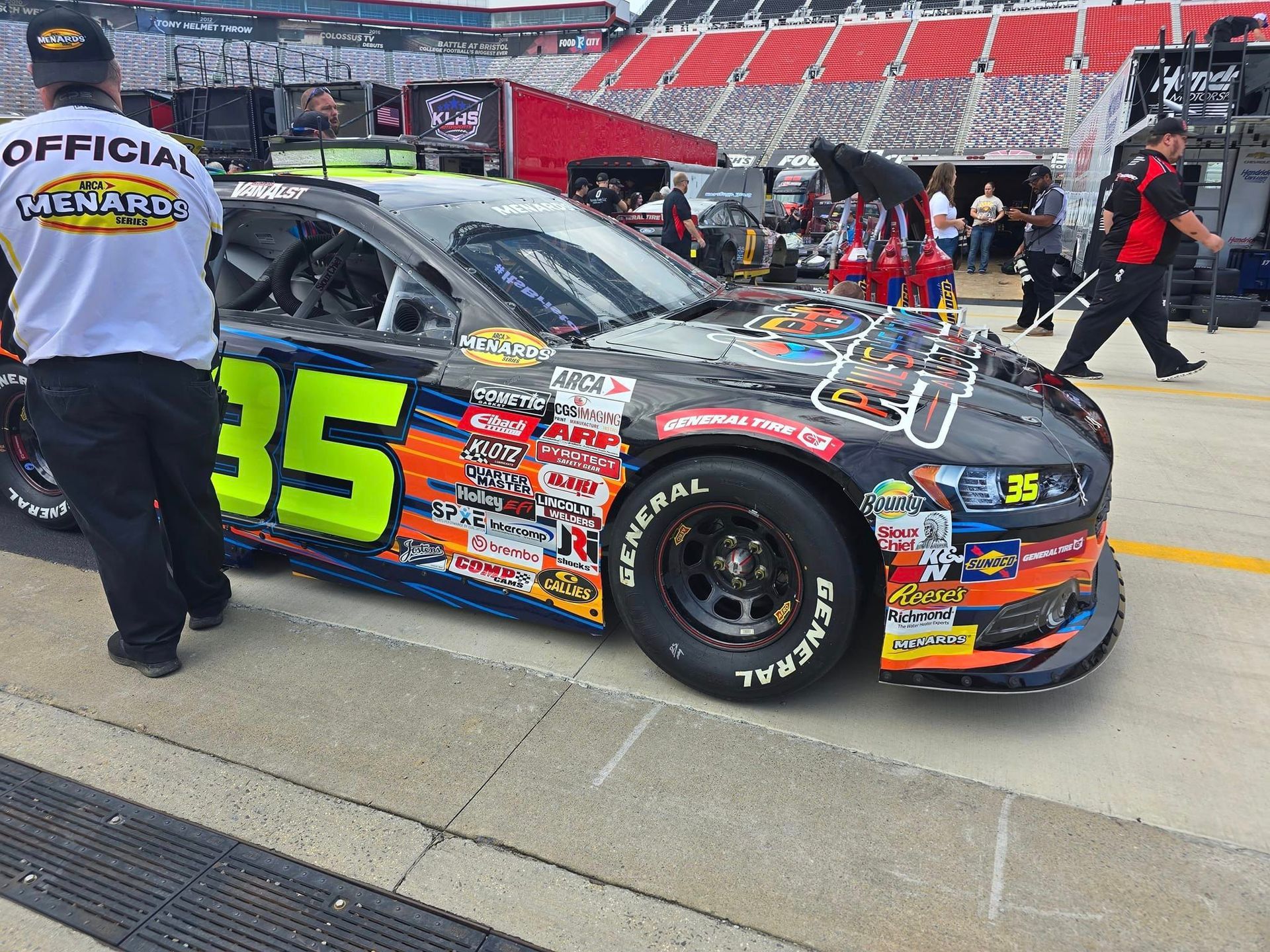 NASCAR stock car No. 35 in pit lane with crew members beside it at a racetrack