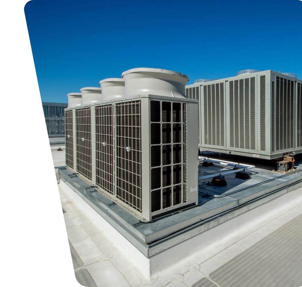 Contact Us Rooftop HVAC units on a white commercial building under a clear blue sky