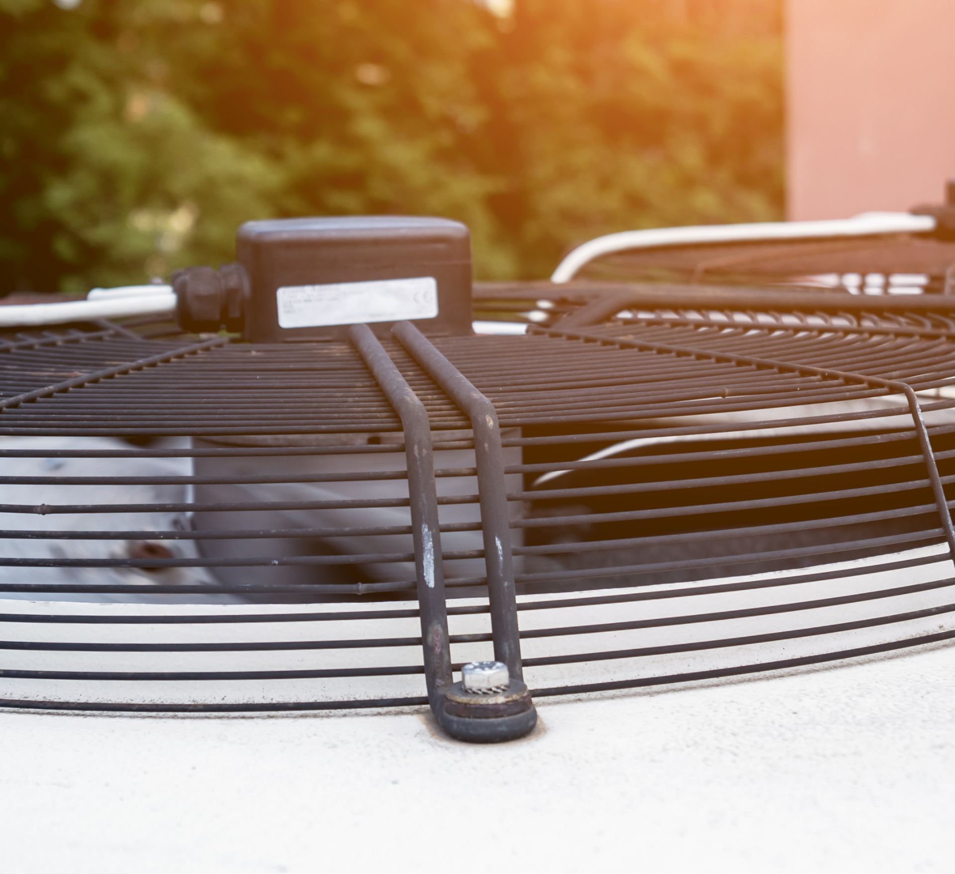 Contact Us to Schedule Service A close up of a fan on top of a building.