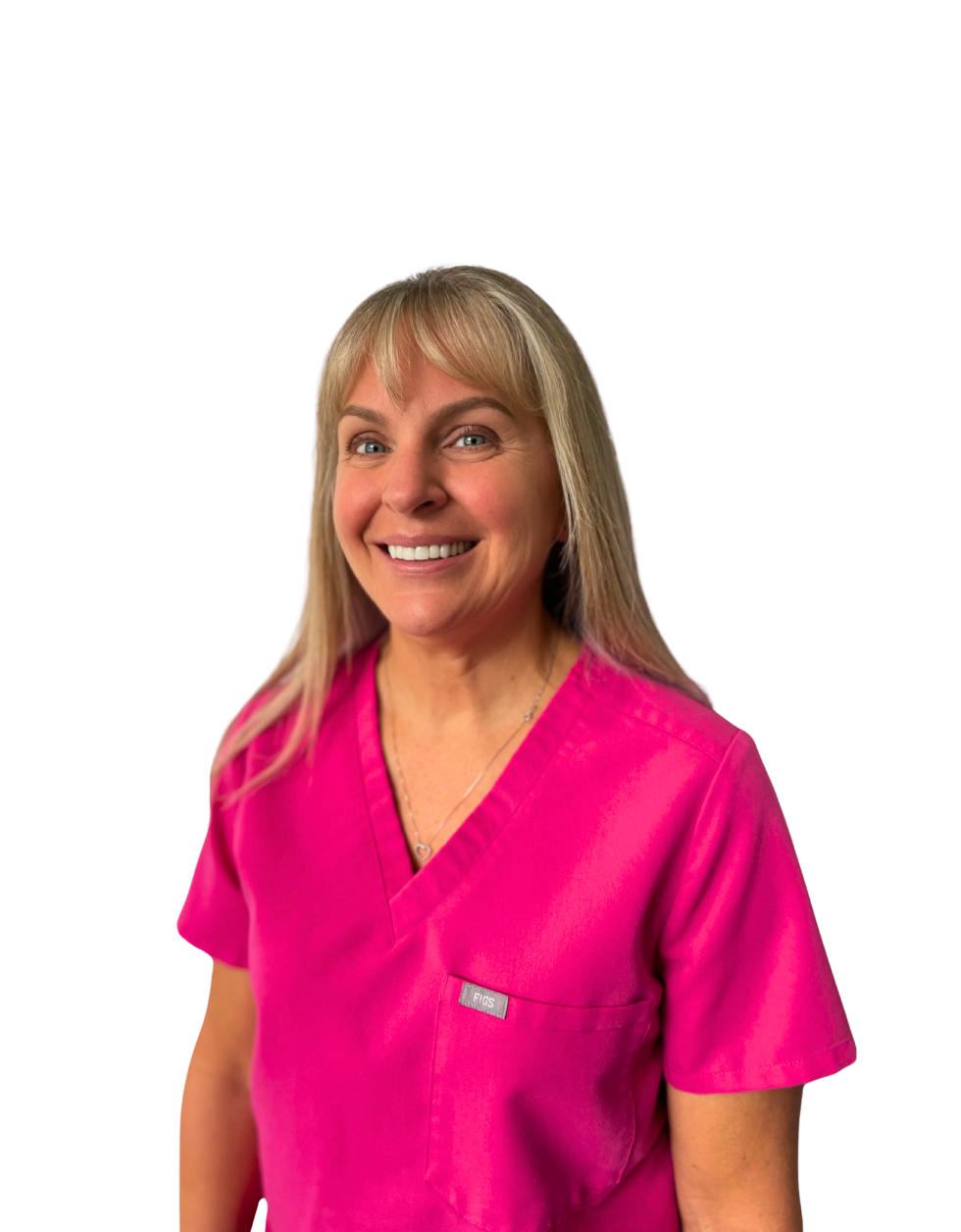Certified Dental Assistant Donna from Ethos Dental Studio in Langley, BC smiling in bright pink scrubs against a white background
