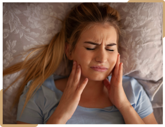 Woman experiencing jaw pain and TMJ discomfort, treated at Ethos Dental Studio in Langley