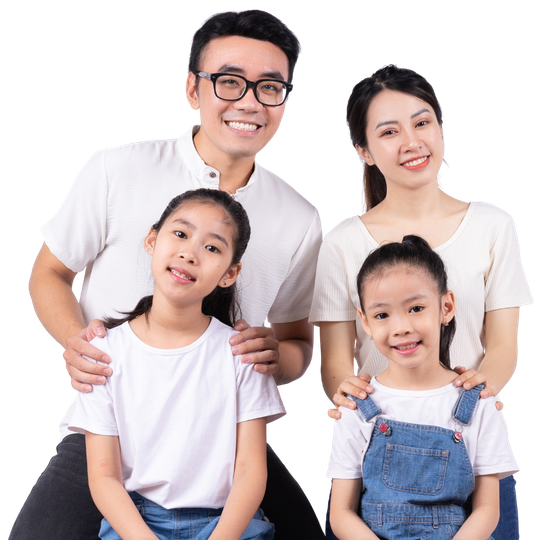 Happy family of four smiling together, showcasing healthy teeth and family dental care at Ethos Dental Studio in Langley, BC