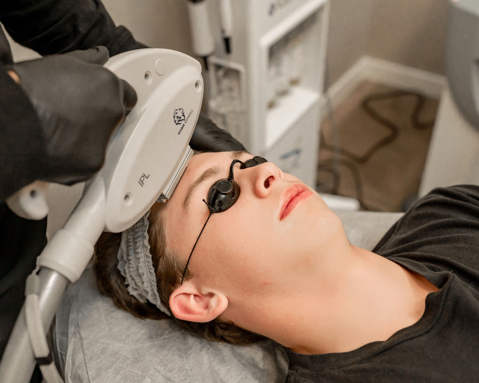 A man is getting a laser treatment on his face.
