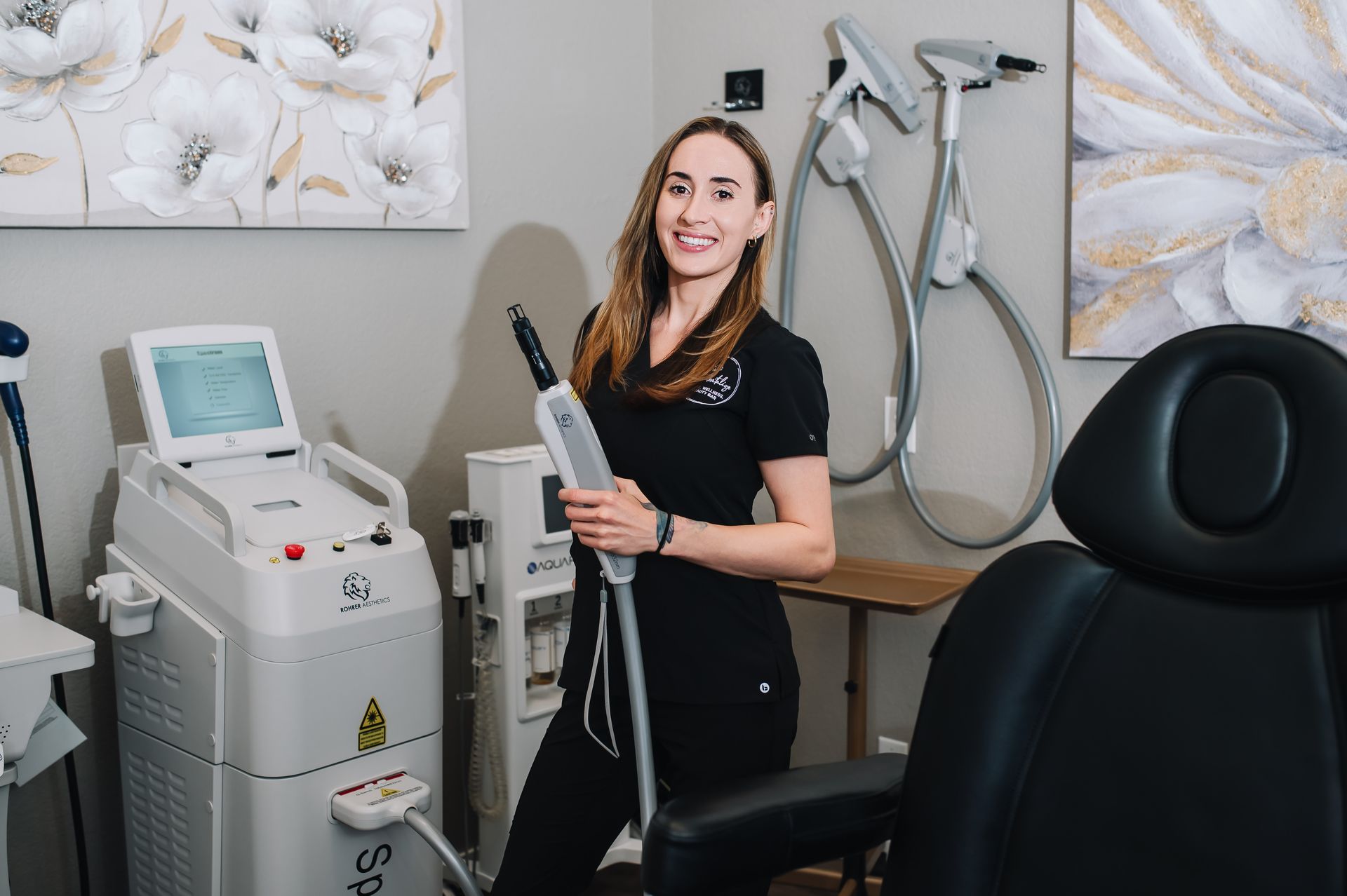A woman is standing in a room holding a machine.