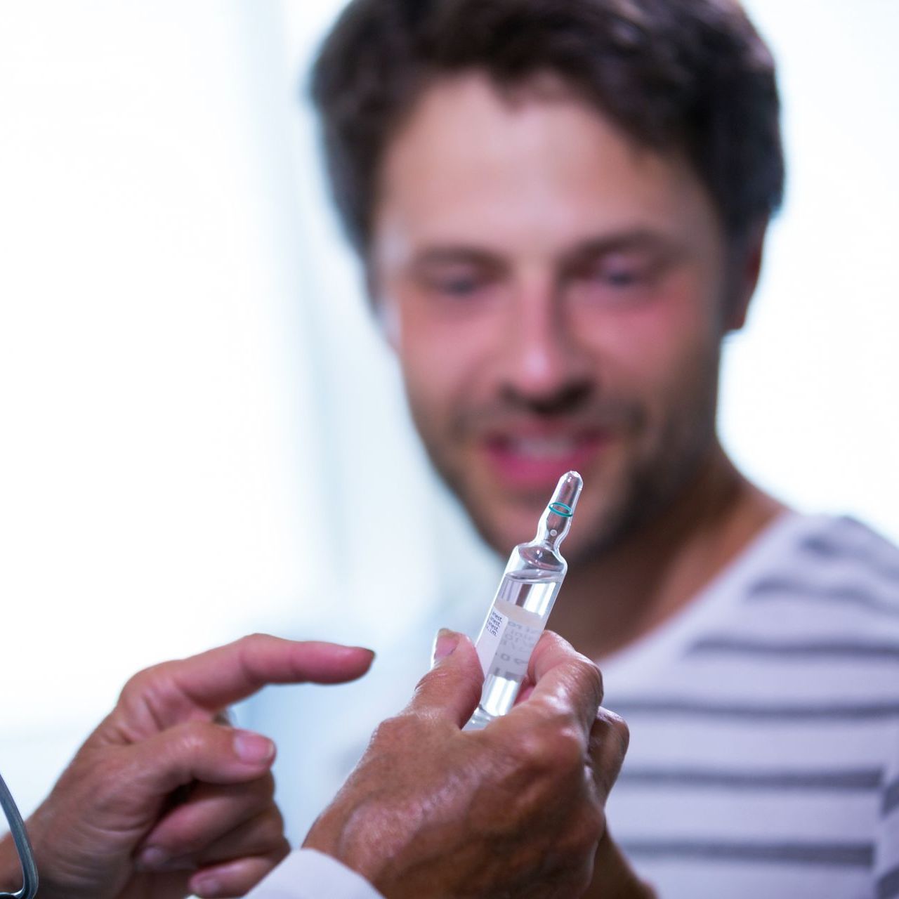 A man is getting an injection from a doctor